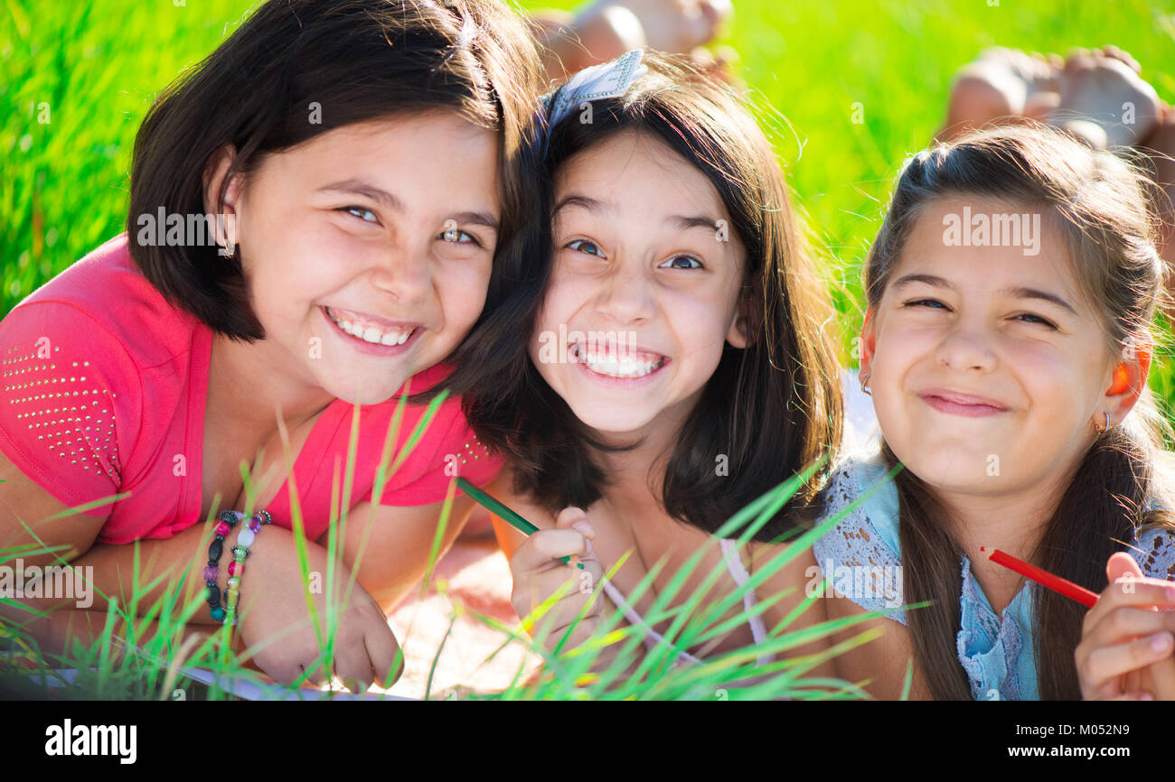Three happy teen girls having fun at park Stock Photo - Alamy