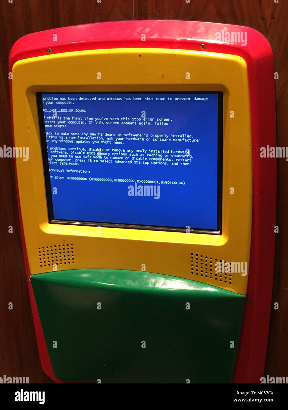 This image captures a Blue Screen of Death (BSoD) error message displayed on a computer at a McDonald's restaurant. The malfunction symbolizes common technical issues experienced in public spaces with modern technology. Stock Photo