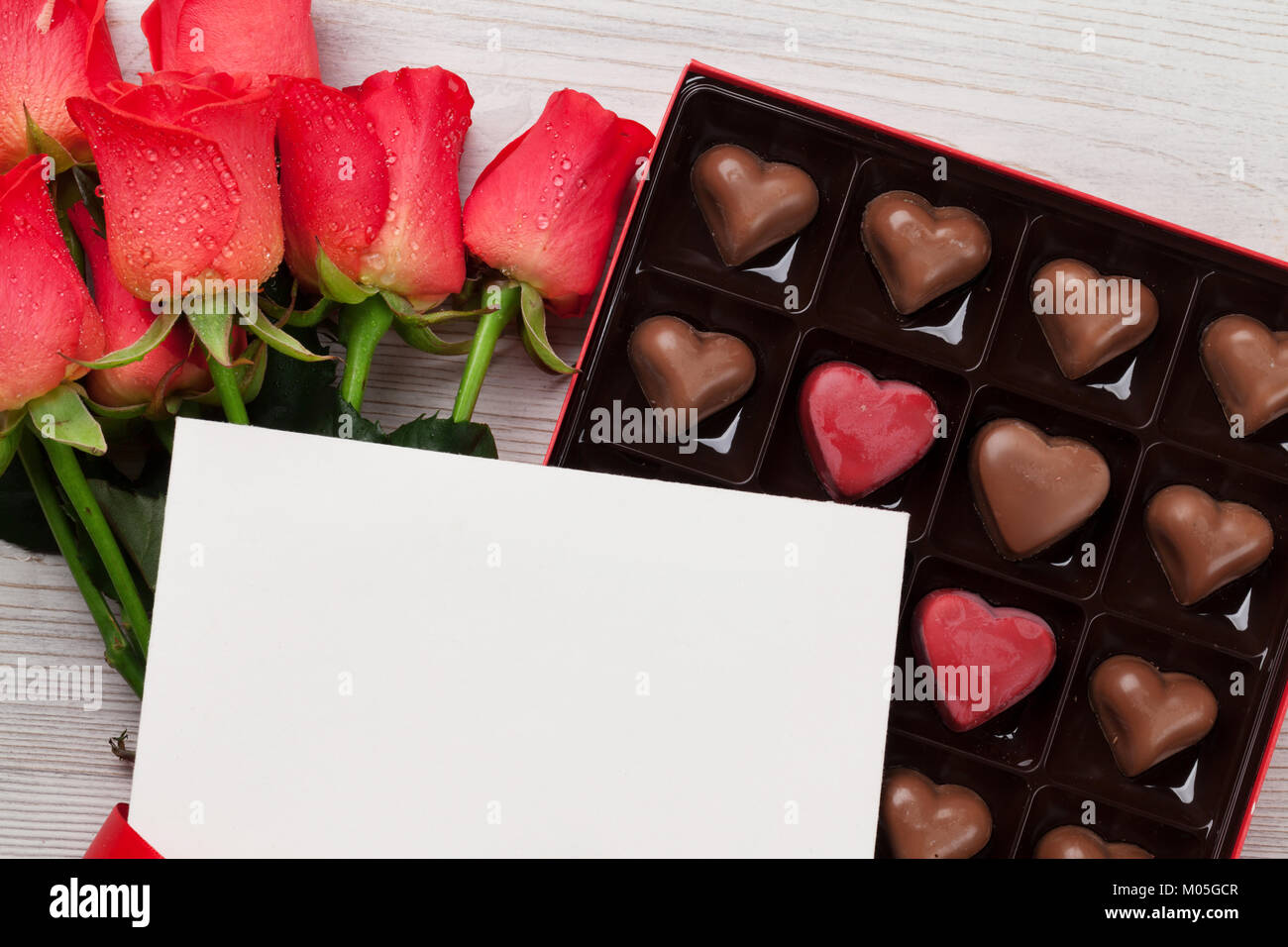 Valentines day greeting card with red roses and heart shaped chocolate ...