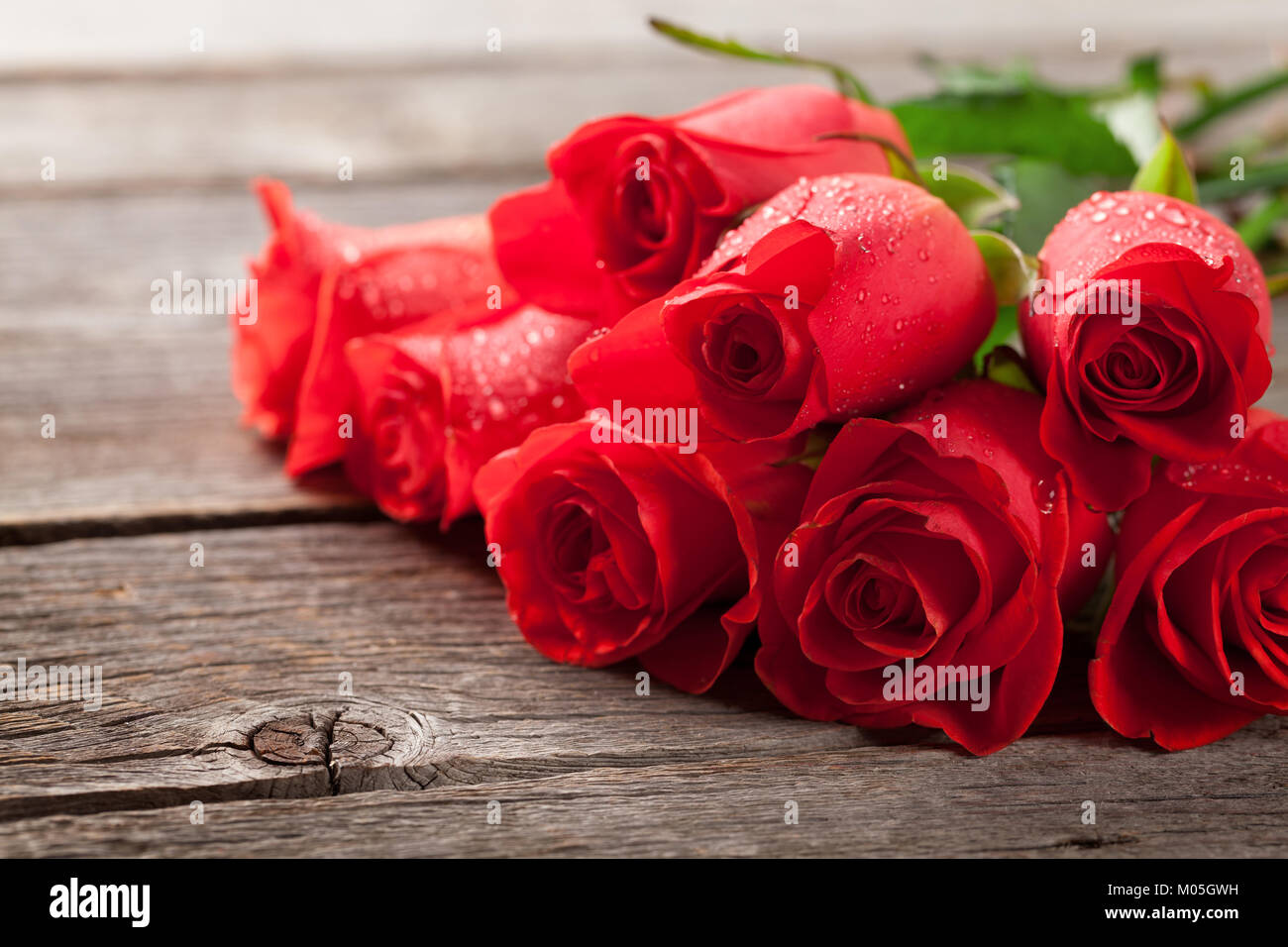 Valentines day greeting card with red roses on wooden table Stock Photo ...