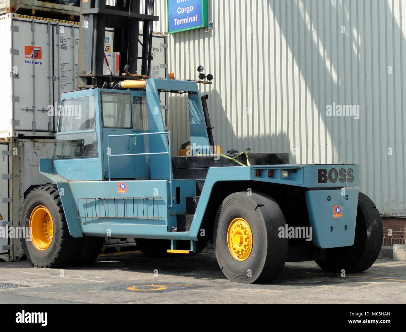 A BOSS SISU forklift is shown at the Dover port, demonstrating its robust design and utility in logistics and cargo handling. The forklift is essential for managing heavy loads in industrial settings. Stock Photo