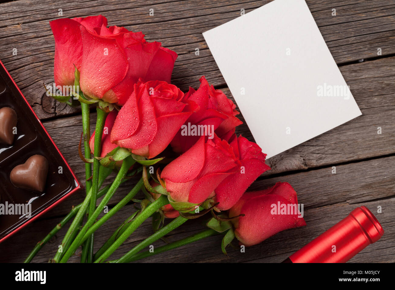 Valentines day greeting card with red roses and heart shaped chocolate ...