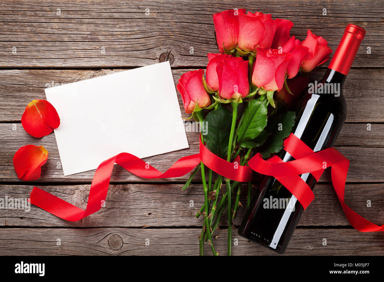 Valentines day greeting card with red wine and rose flowers on wooden ...