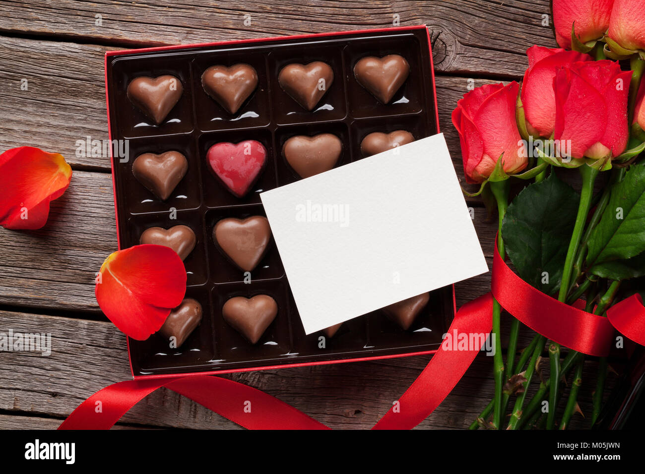 Valentines day greeting card with red roses and heart shaped chocolate ...