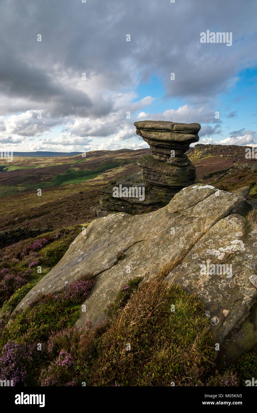The Salt Cellar on Derwent Edge in the Peak District national park. A gritstone rock formation surrounded by Heather. Stock Photo