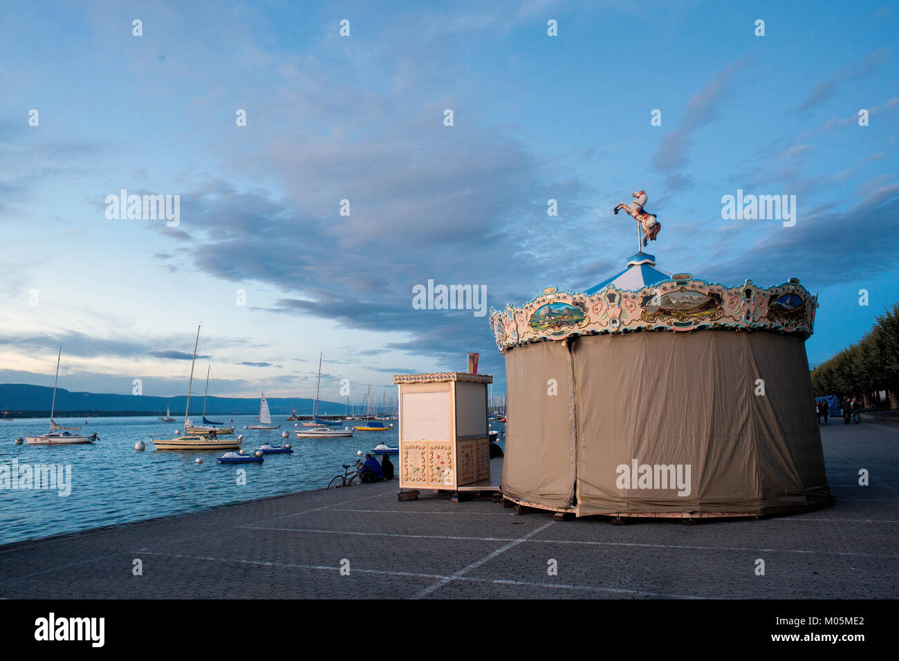 GENEVA, SWITZERLAND, the lake at night / october 11, 2017 : before winter there is only one old carousel left on the wharf Stock Photo