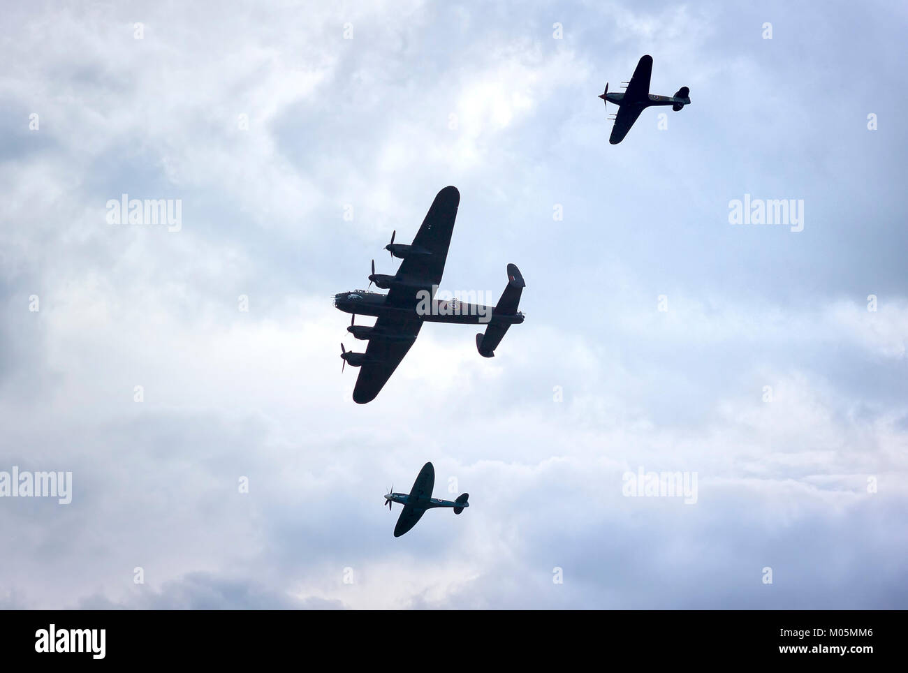 Threatening skies add atmosphere to the Battle of Britain Memorial Flight formation in the UK Stock Photo