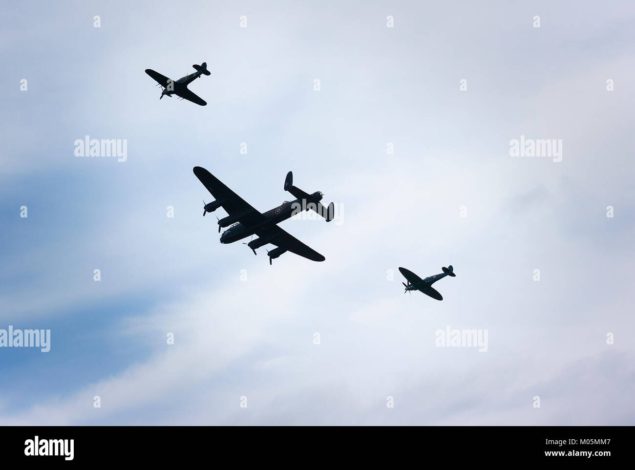 A formation of the Battle of Britain Memorial Flight Hurrican, Lancaster and Spitfire flying over Gloucestershire England UK7 Stock Photo