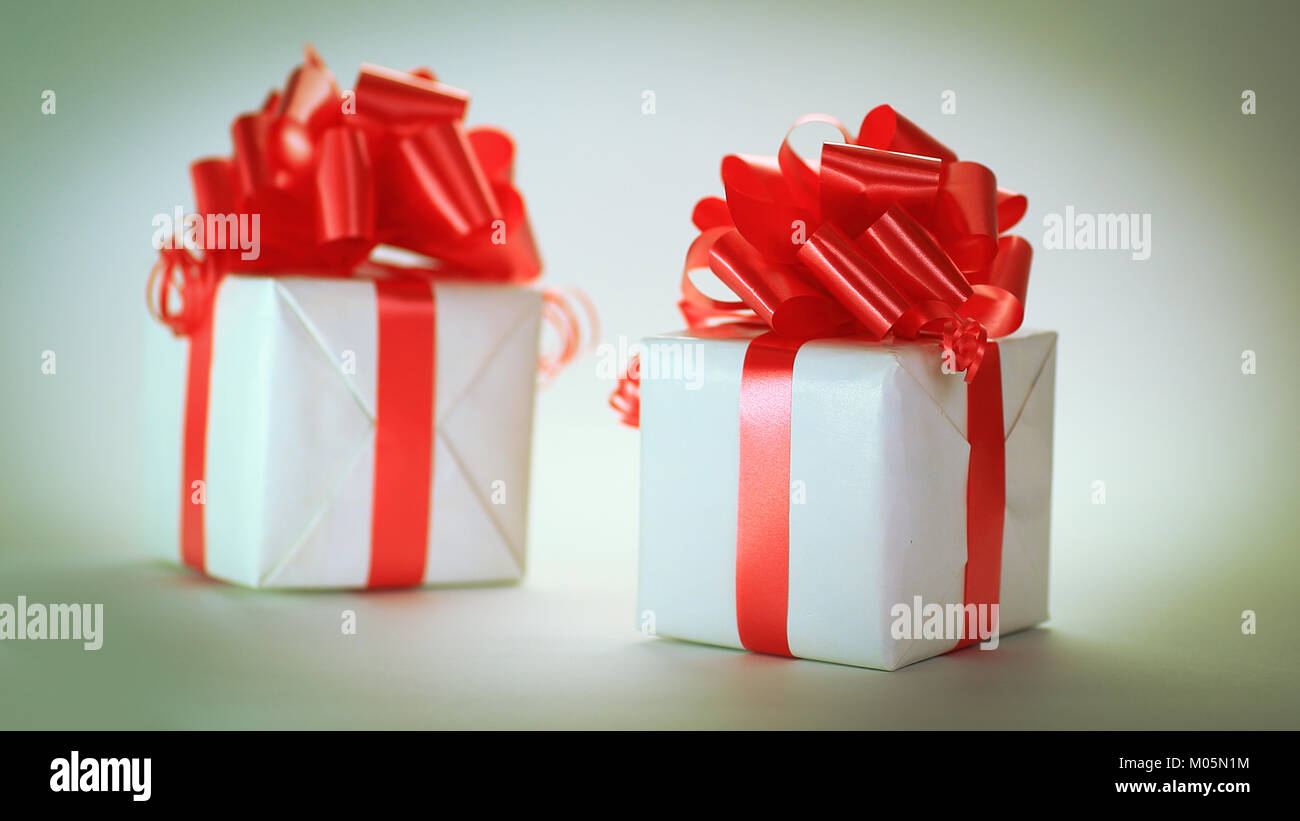 Two Ribbons Gift two white gift box with red ribbon .isolated on white Stock Photo - Alamy