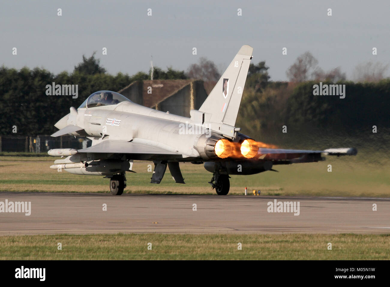 RAF Eurofighter Typhoon from 17 Squadron powering down the  Coningsby runway in full reheat/afterburner, which is rarely used. Stock Photo