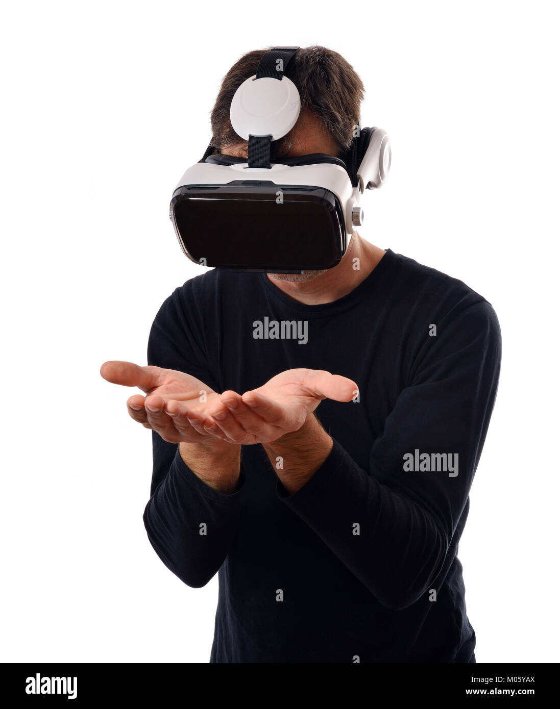Serious man with black sweater and virtual reality glasses interacting ...