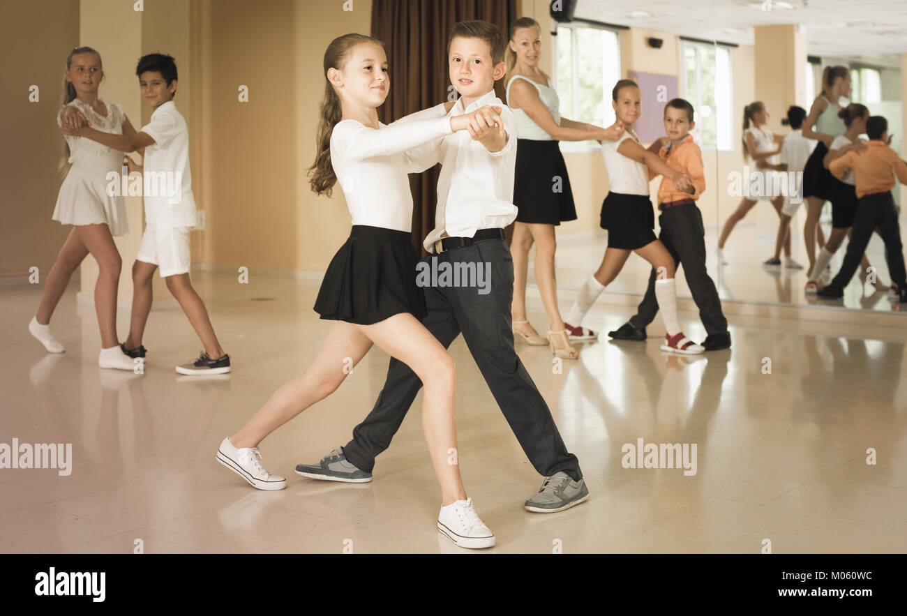 smiling spanish children dancing pair dance in class Stock Photo Alamy