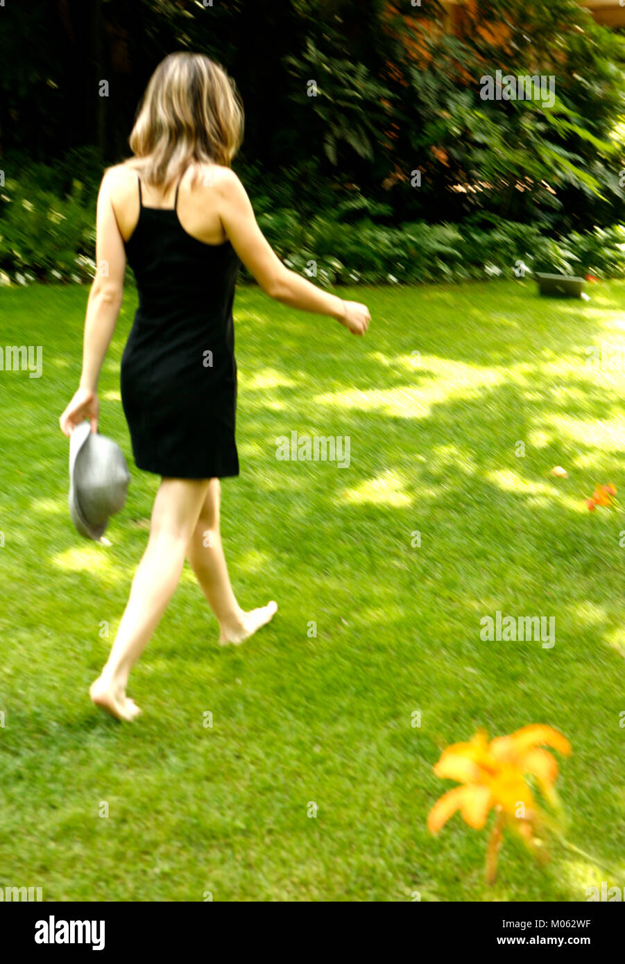 Woman walking barefoot grass garden hi-res stock photography and images ...