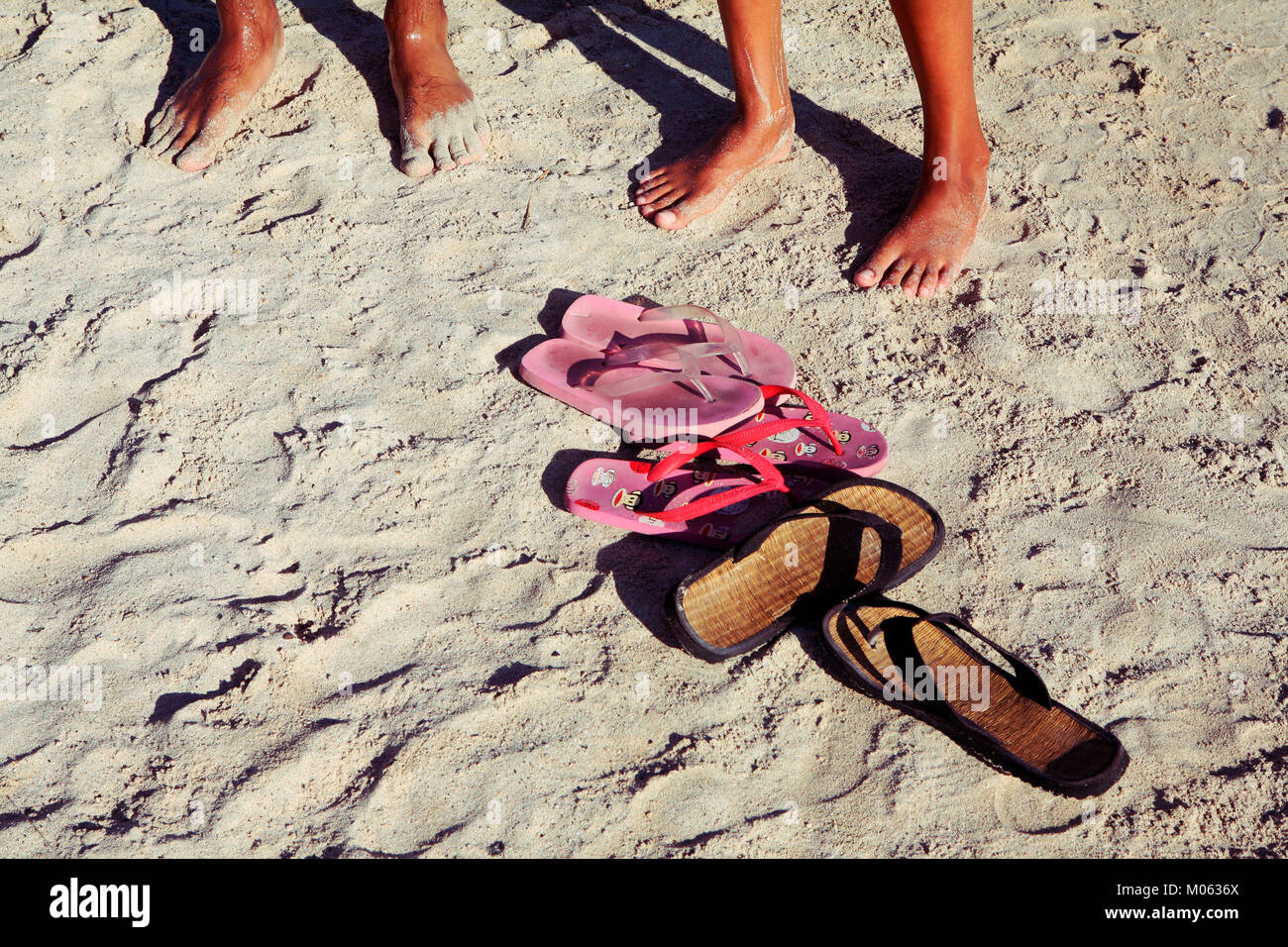 feet of boys on the beach with flip flops Stock Photo - Alamy