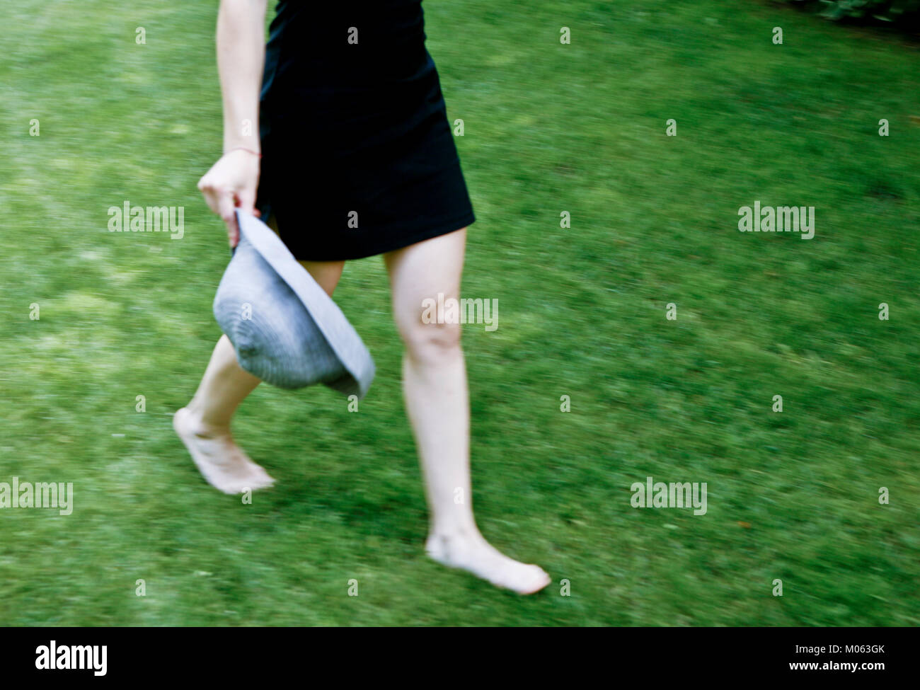 woman walking barefoot on the grass Stock Photo - Alamy