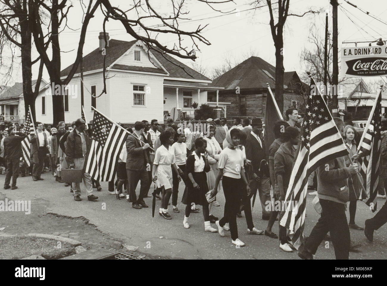 Participants, some carrying American flags, marching in the civil