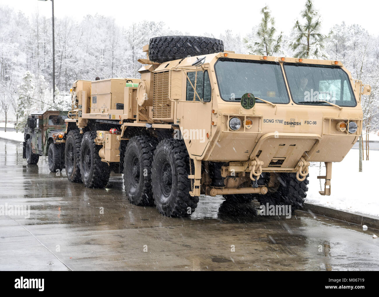U.S. Soldiers with the Field Maintenance Shop 5 Vehicle Recovery Team, South Carolina National Guard, help assist Highway Patrol with vehicle recovery during a snow storm in Rock Hill, South Carolina, Jan. 17, 2018. Stock Photo