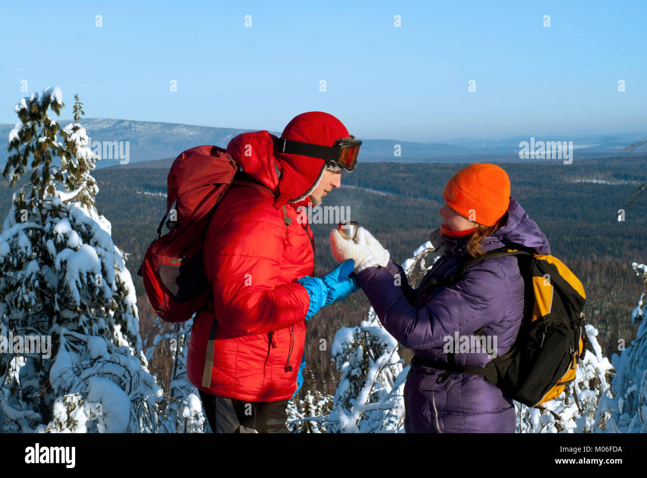 Two hikers on top of the mountain on a clear frosty day against the ...