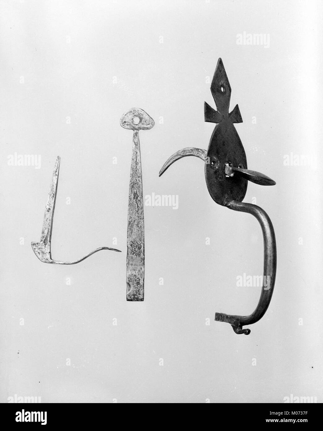 This latch, bar, and catch mechanism is part of a larger object, likely ...