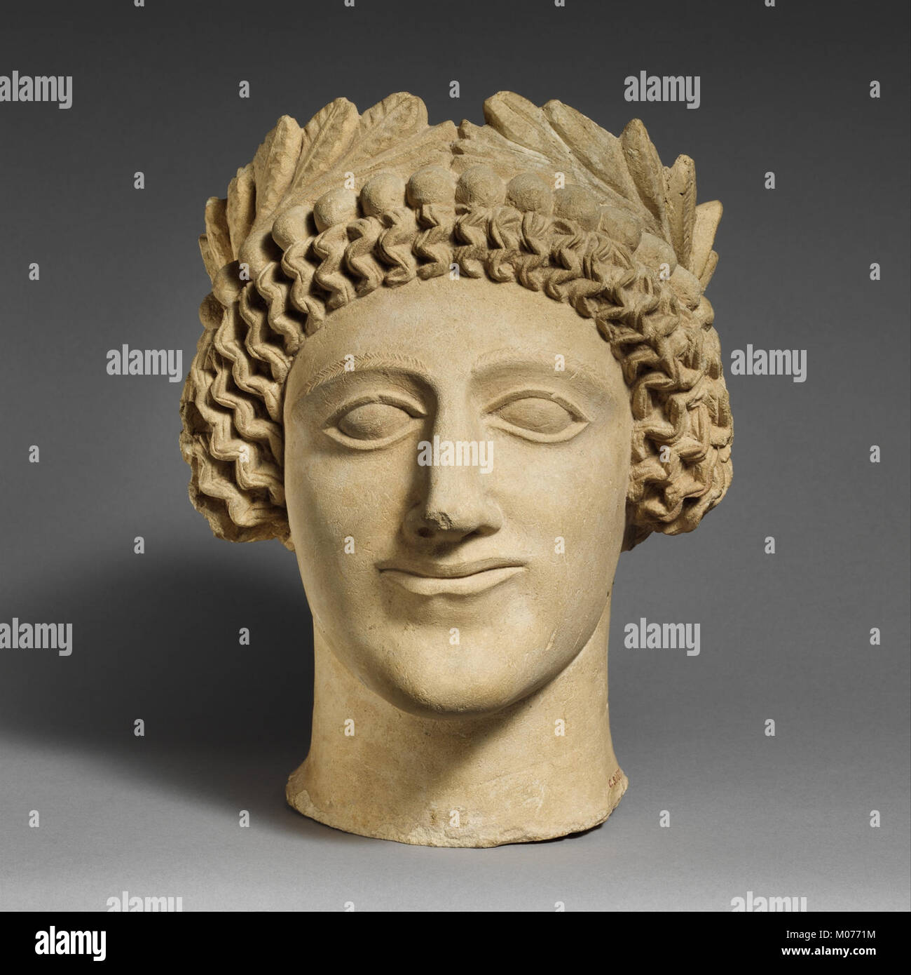 Limestone head of a youth with wreath MET DP165215 Stock Photo - Alamy