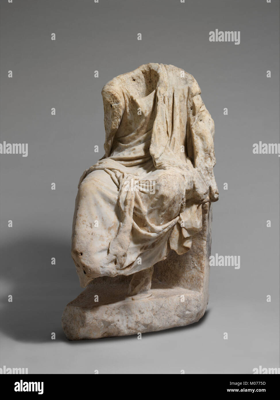 This marble statue of a draped seated man demonstrates classical ...