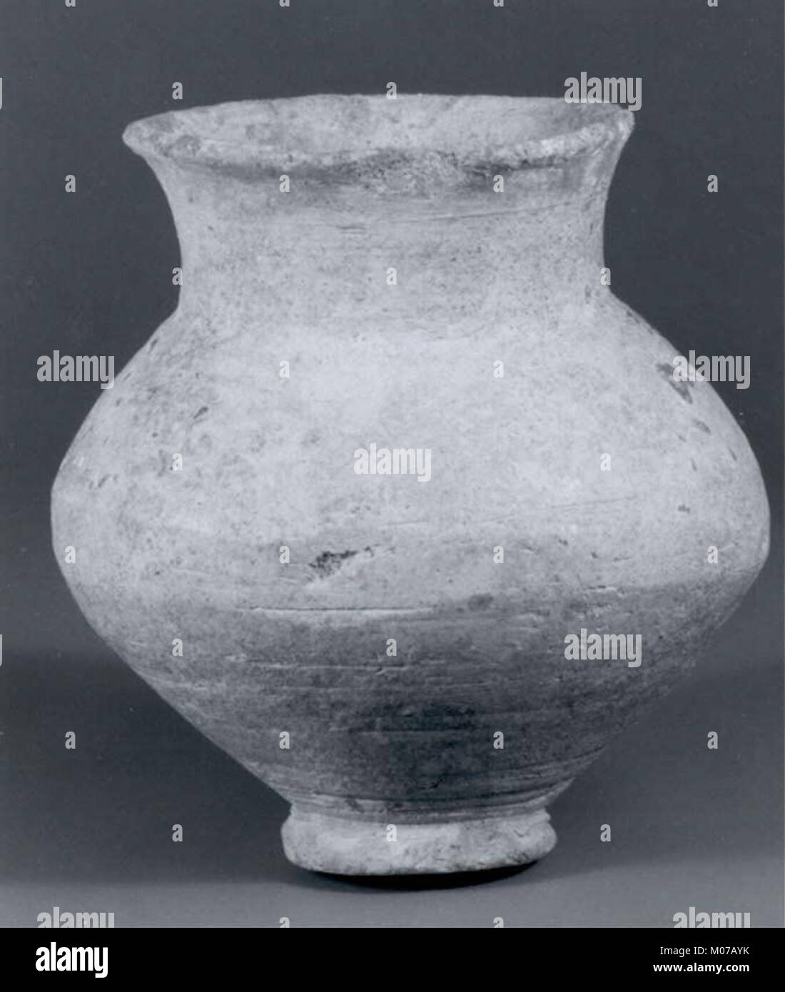 This jar, an ancient clay vessel, demonstrates early pottery techniques ...