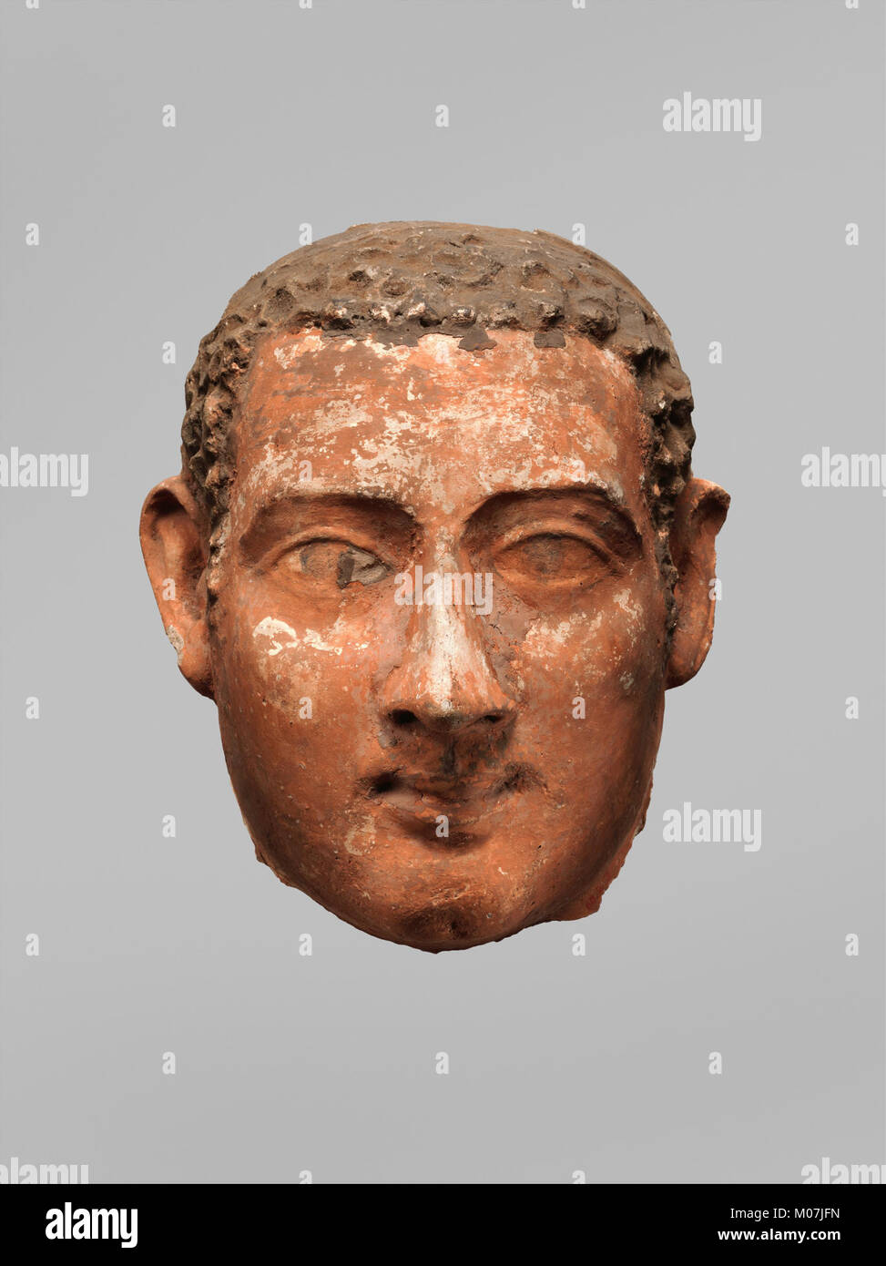 Mask Of A Man With Short Curly Hair And Long Sideburns Met