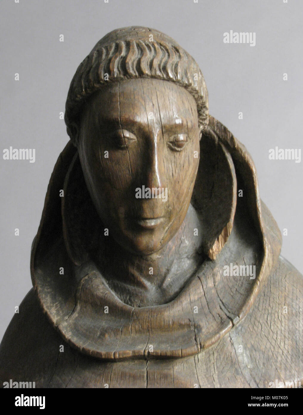 The sculpture depicts a monastic saint, highlighting religious ...