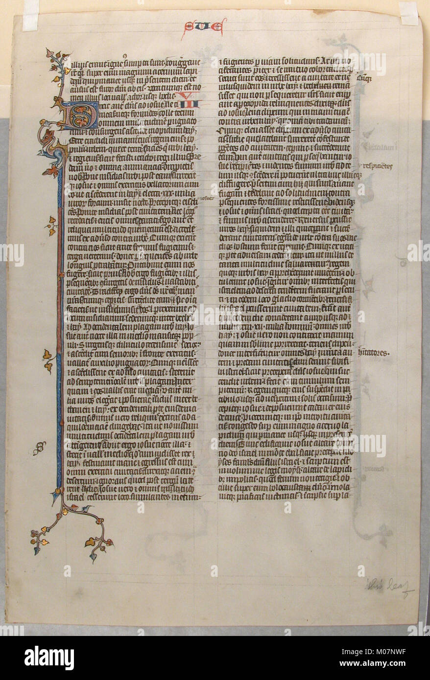 A Bible manuscript leaf showing religious text with decorative script ...