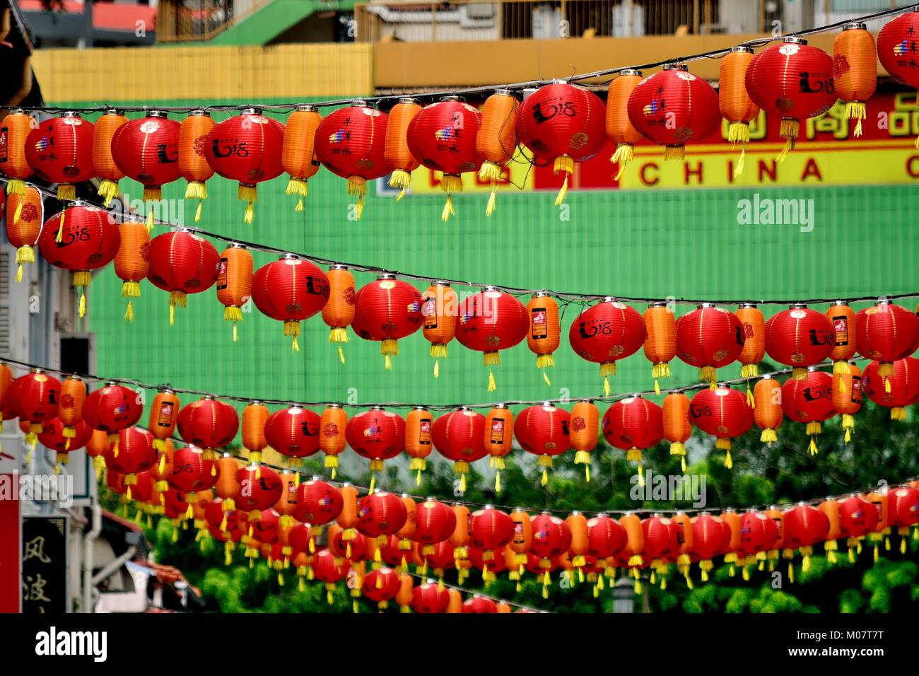 Red Chinese lanterns hanging across a street in historic Chinatown
