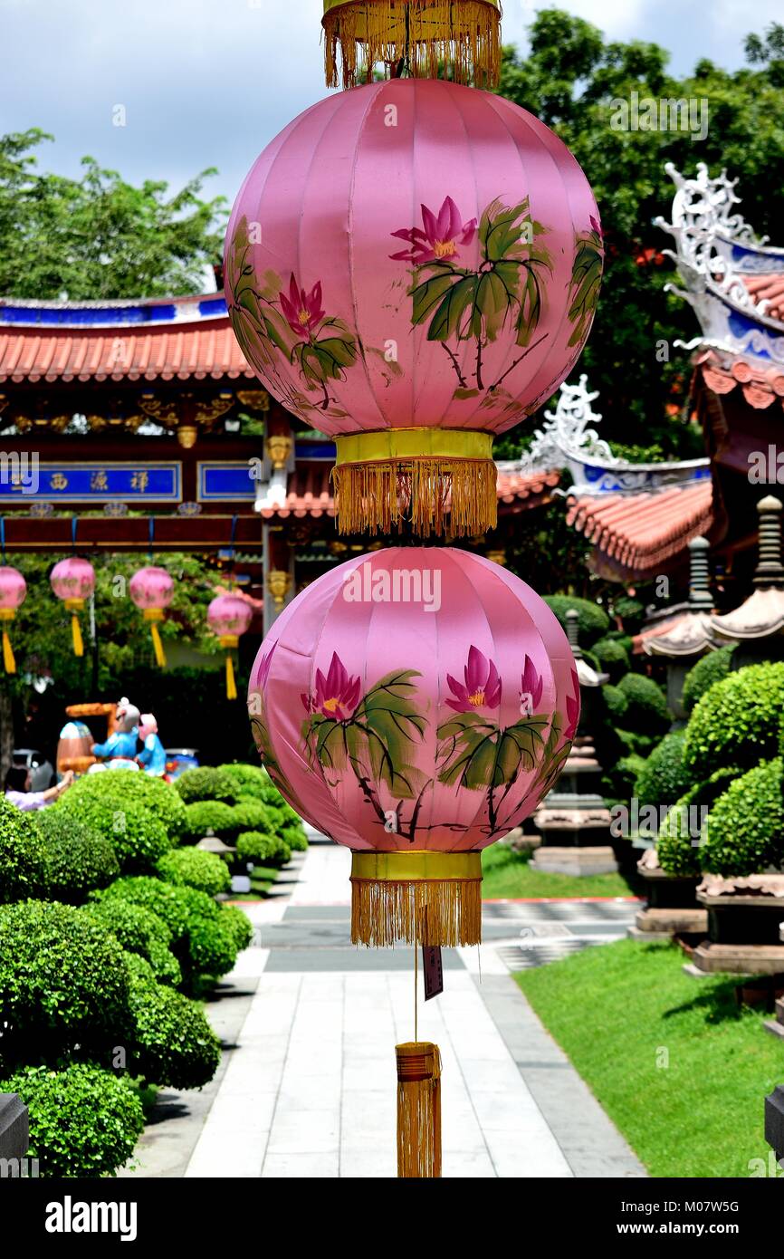 Beautiful pink Chinese lanterns hanging from a classical archway celebrating Chinese Lunar New Year at Siong Lim Buddhist Monastery in Singapore Stock Photo