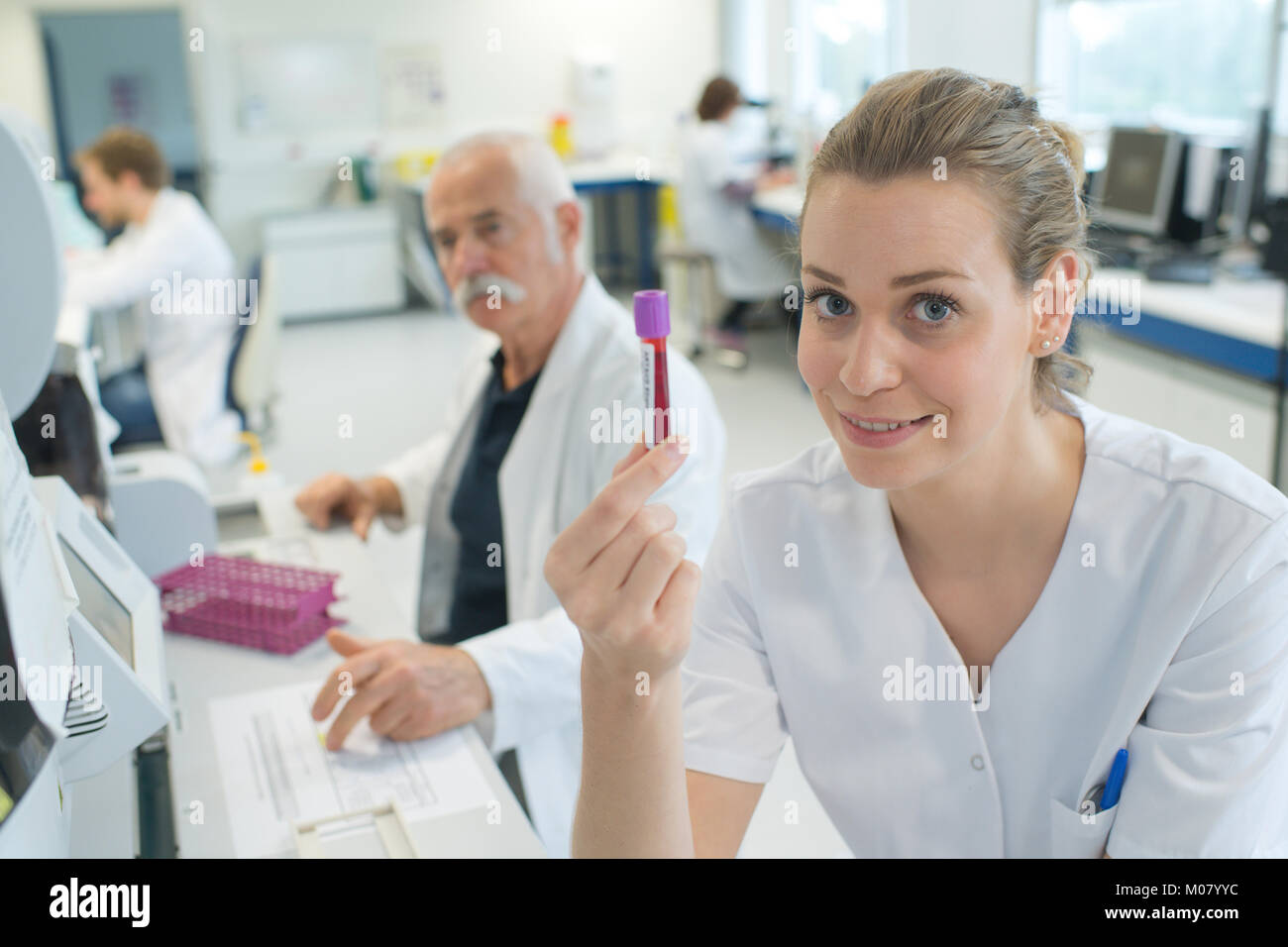 attractive female doctor showing a blood test Stock Photo Alamy