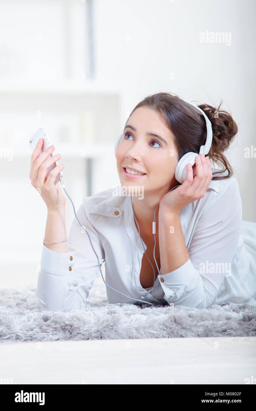 Laying on the floor listening to music Stock Photo - Alamy