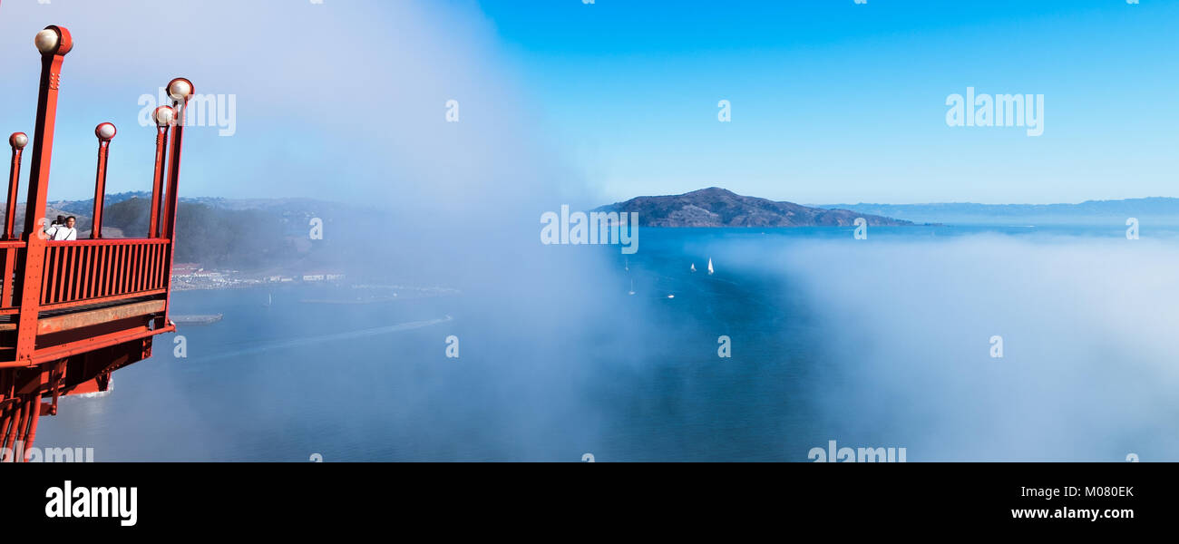 Golden Gate Bridge side platform extension for bridge pedestrians to view the San Francisco Bay and Angel Island. Fog drifts over the water. Stock Photo