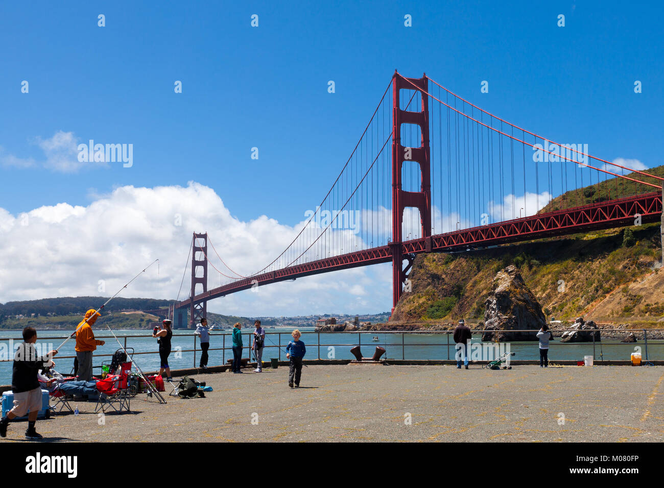 Golden Gate Bridge with people fishing in the foreground off the Fort Baker pier. King salmon season. Stock Photo