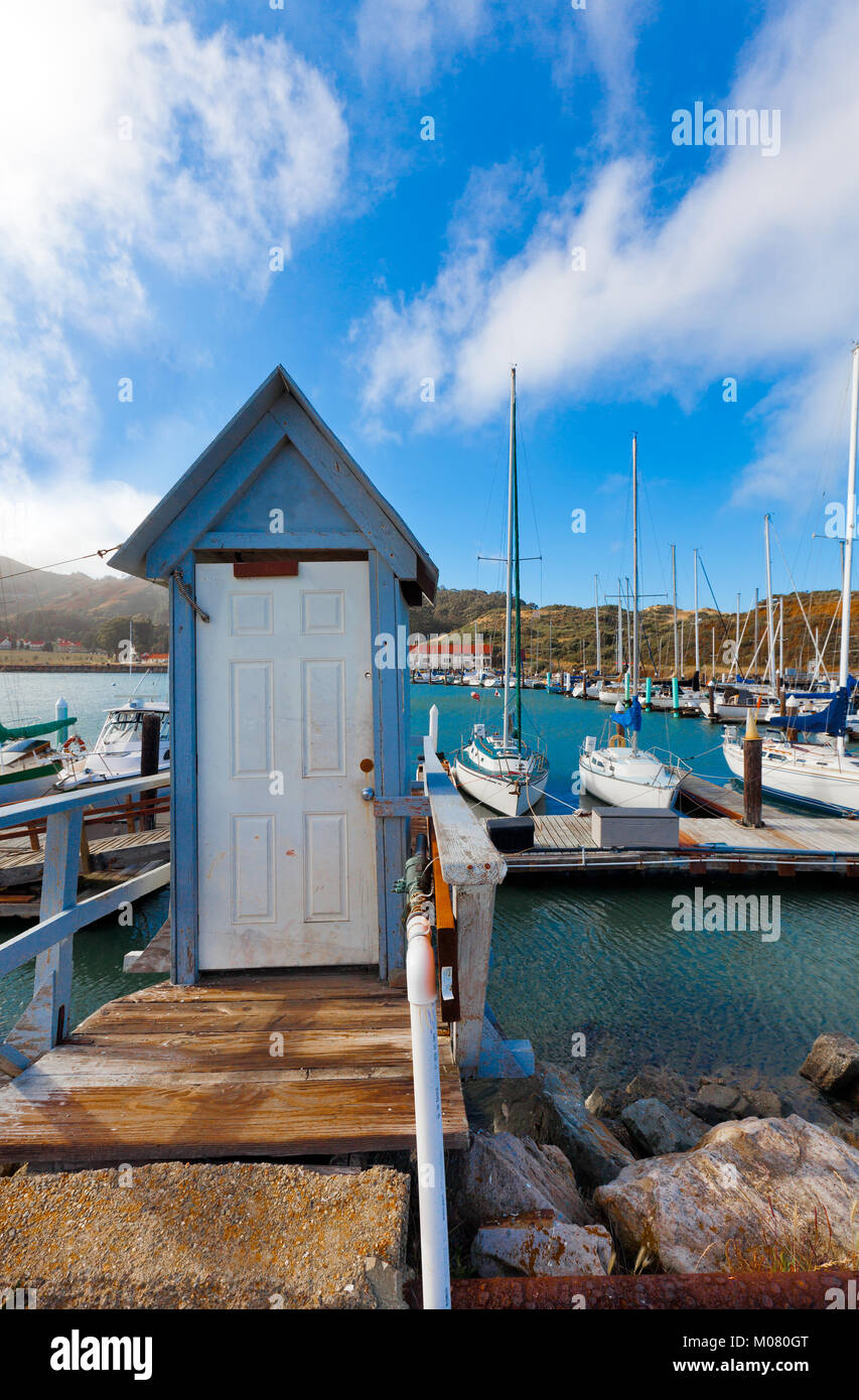 Presidio Yacht Club marina in Sausalito located by the north end of the Golden Gate Bridge. Old door in the foreground marks the entrance to the dock. Stock Photo