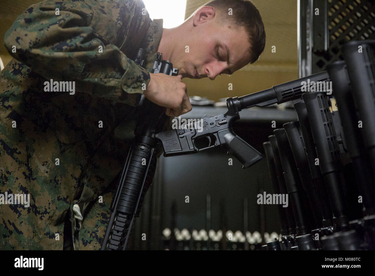LCpl. Jacob Cooper, Victorville, Calif., a 2111 Armorer with Headquarters and Support Bn., Marine Corps Base Camp Pendleton, examines the condition of the lower receiver of an M16A4 rifle during a pre-fire inspection Jan 8, 2018. Prior to an upcoming event or range, limited technical inspections and pre-fire inspections are conducted, ensuring that each weapon is fully operational and cleared for use. (U.S. Marine Corps Stock Photo