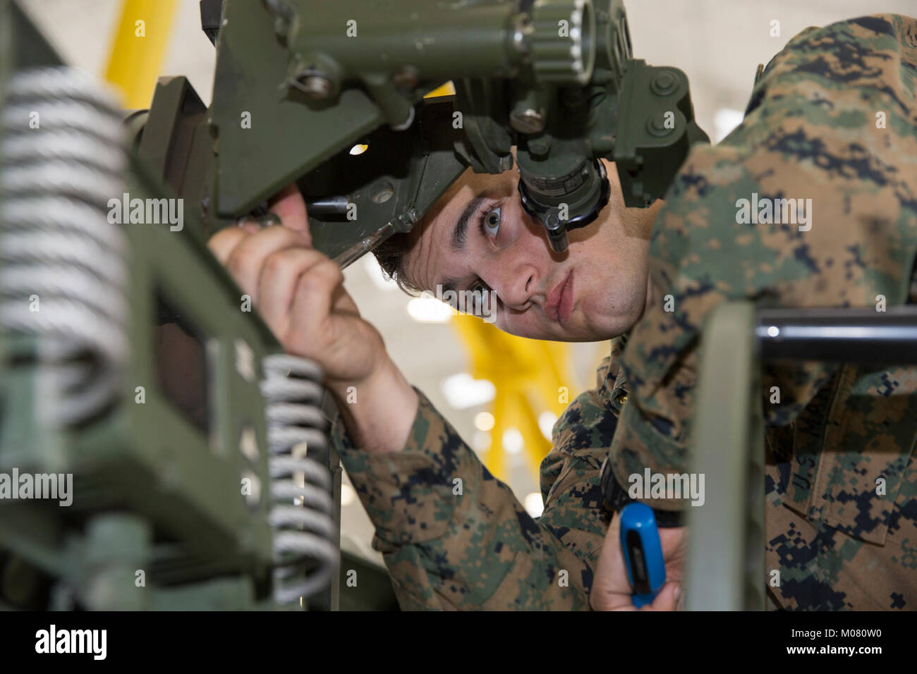 LCpl. Nicholas Wolfe, an electra-optical ordnance repairer with  Headquarters Battery, 11th Marine Regiment, make repairs to the sight of an  M777 towed 155mm howitzer while conducting a fire control alignment on Camp