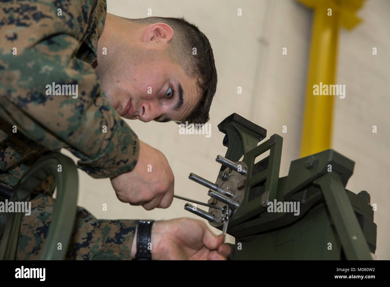 LCpl. Nicholas Wolfe, an electra-optical ordnance repairer with  Headquarters Battery, 11th Marine Regiment, make repairs to the sight of an  M777 towed 155mm howitzer while conducting a fire control alignment on Camp