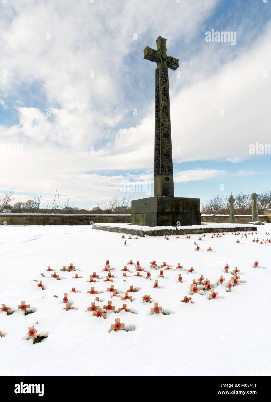 A forest of small wooden crosses planted in snow before the DLI memorial cross in Palace Green, Durham City, England, UK Stock Photo