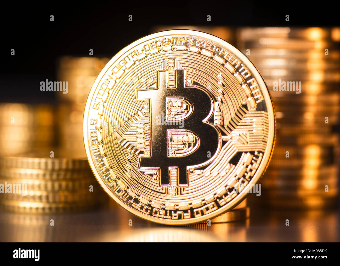 Bitcoin with coin stacks in the background Stock Photo