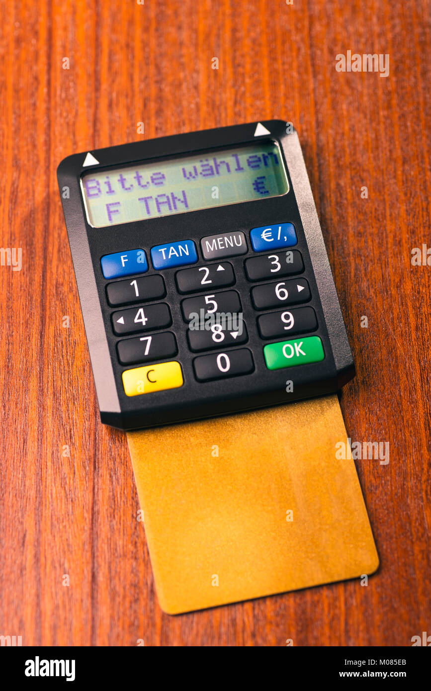 Tan generator with credit card lying on a desk Stock Photo