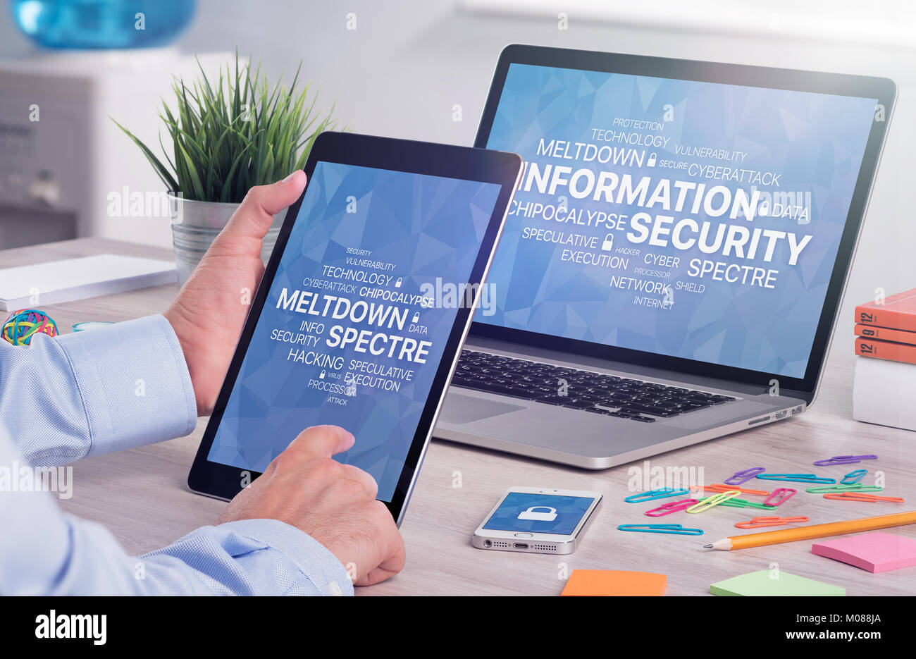 Information security concept on digital tablet pc in male hands and laptop screen Stock Photo
