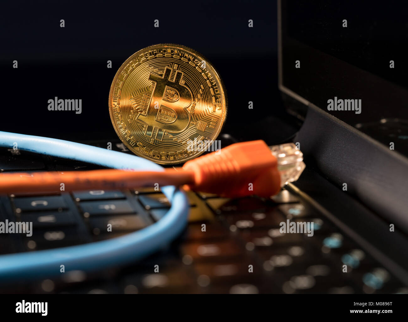 Bitcoin coin standing on keyboard of computer Stock Photo - Alamy