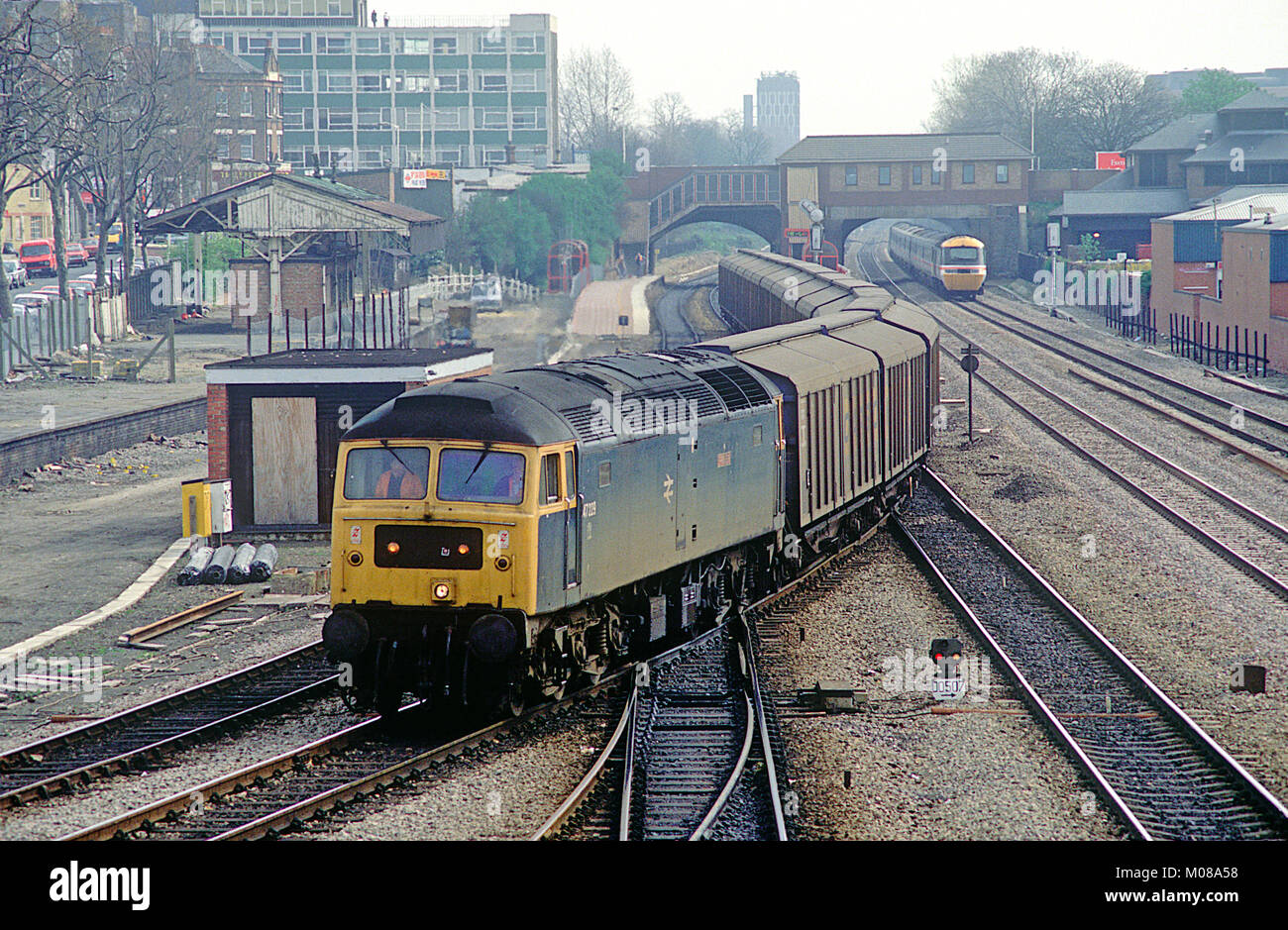 A class 47 diesel locomotive number 47299 heads onto the Greenford branch with a rake of ferry vans at West Ealing. 10th April 1991. Stock Photo