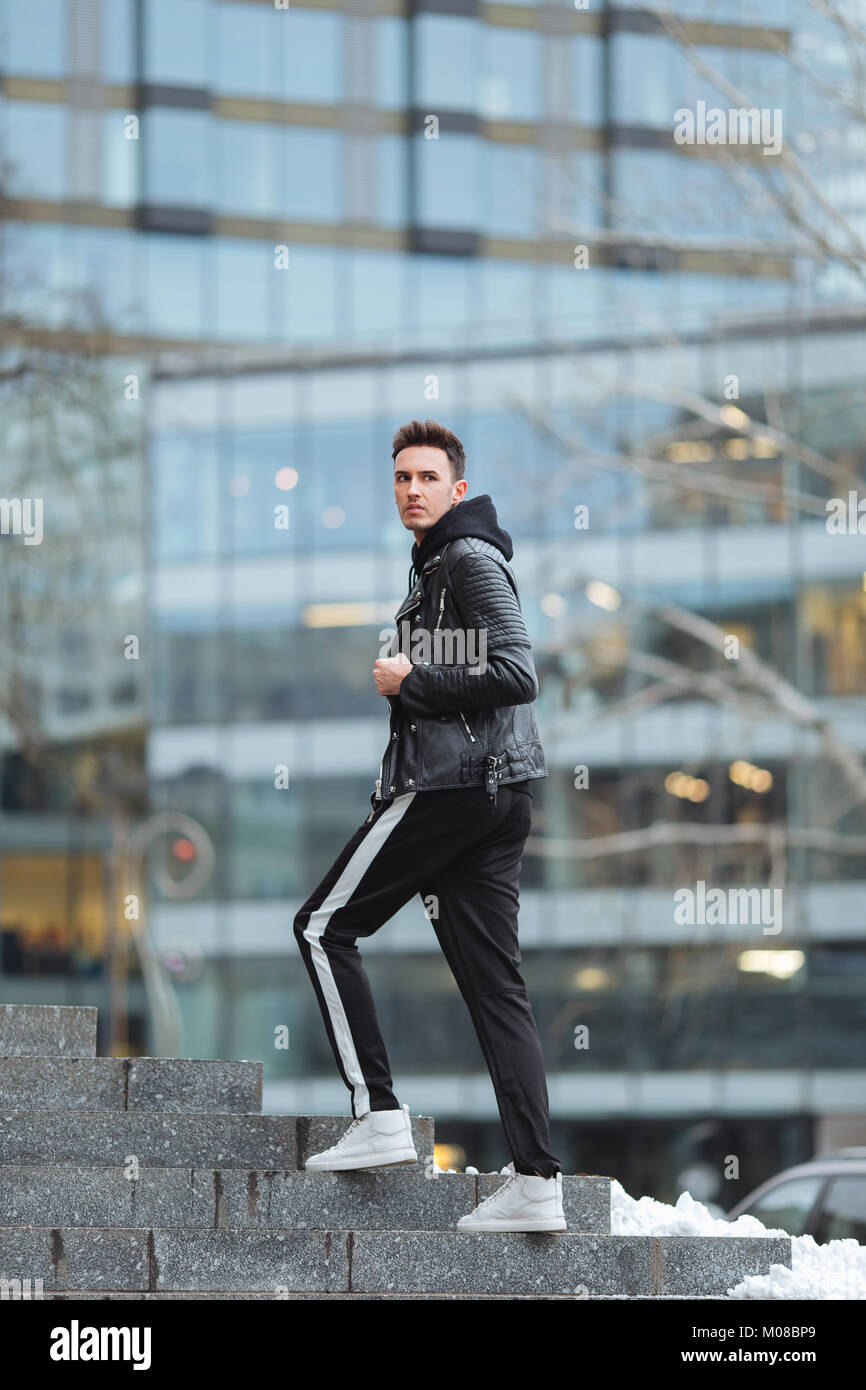 Portrait of man look around. Stylish clothing wear. Autumn and winter  weather. Jacket with white sneakers. Blur background, proffesional photo  Stock Photo - Alamy