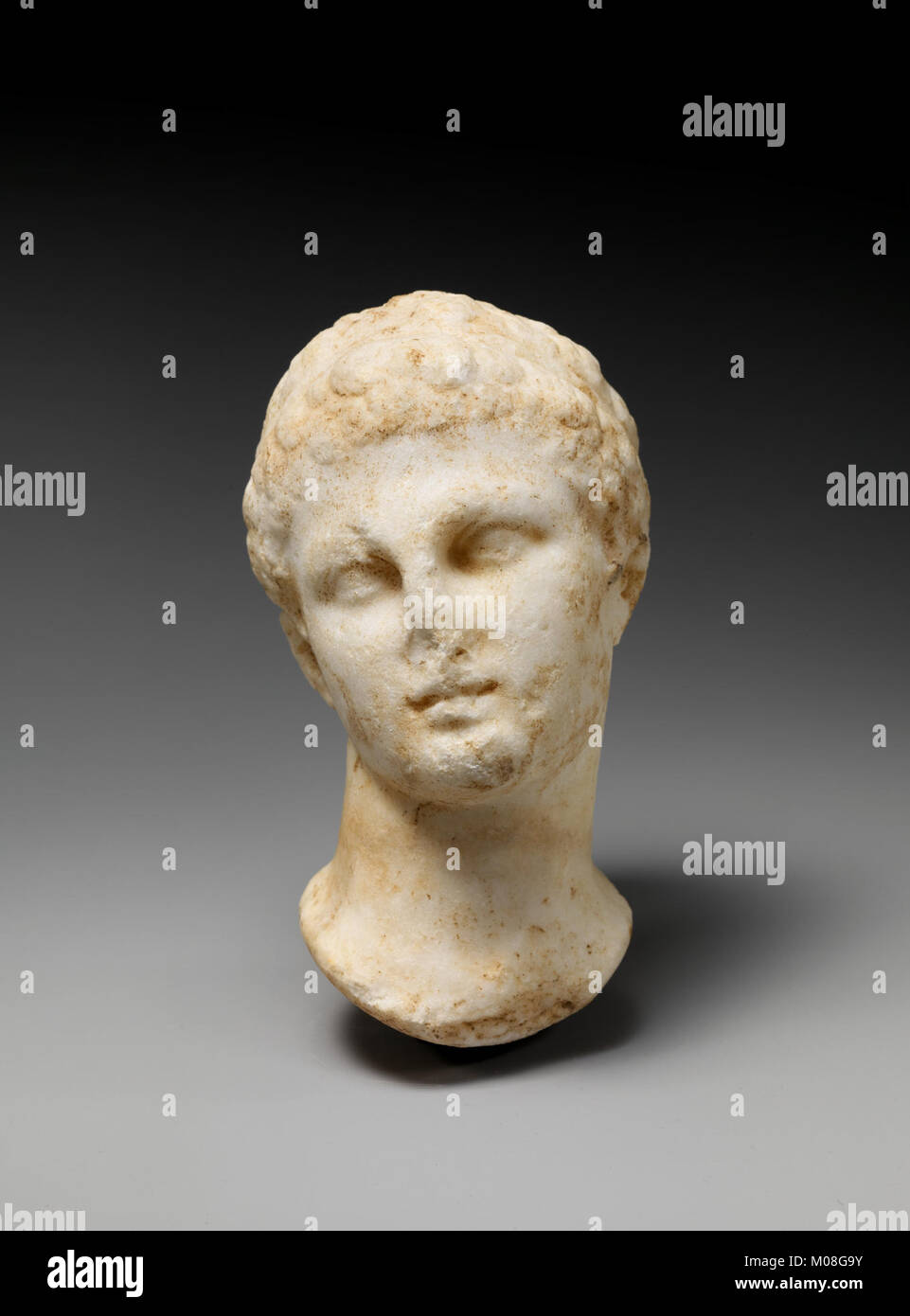 A marble sculpture of a youthful figure in classical Greek style ...