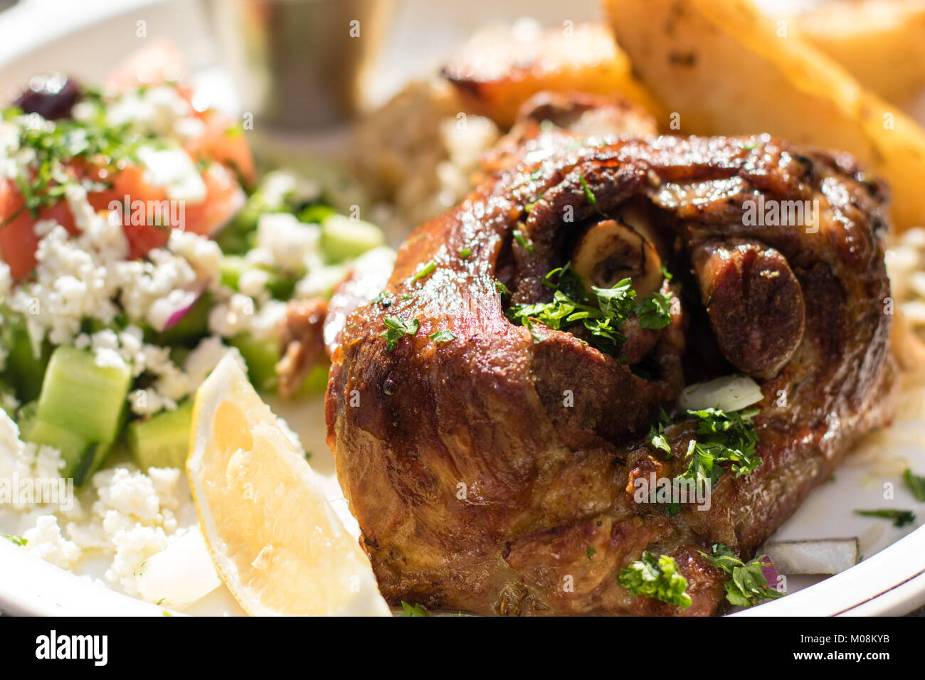 Hot and juicy roasted lamb with greek salad. Authentic Greek food Stock