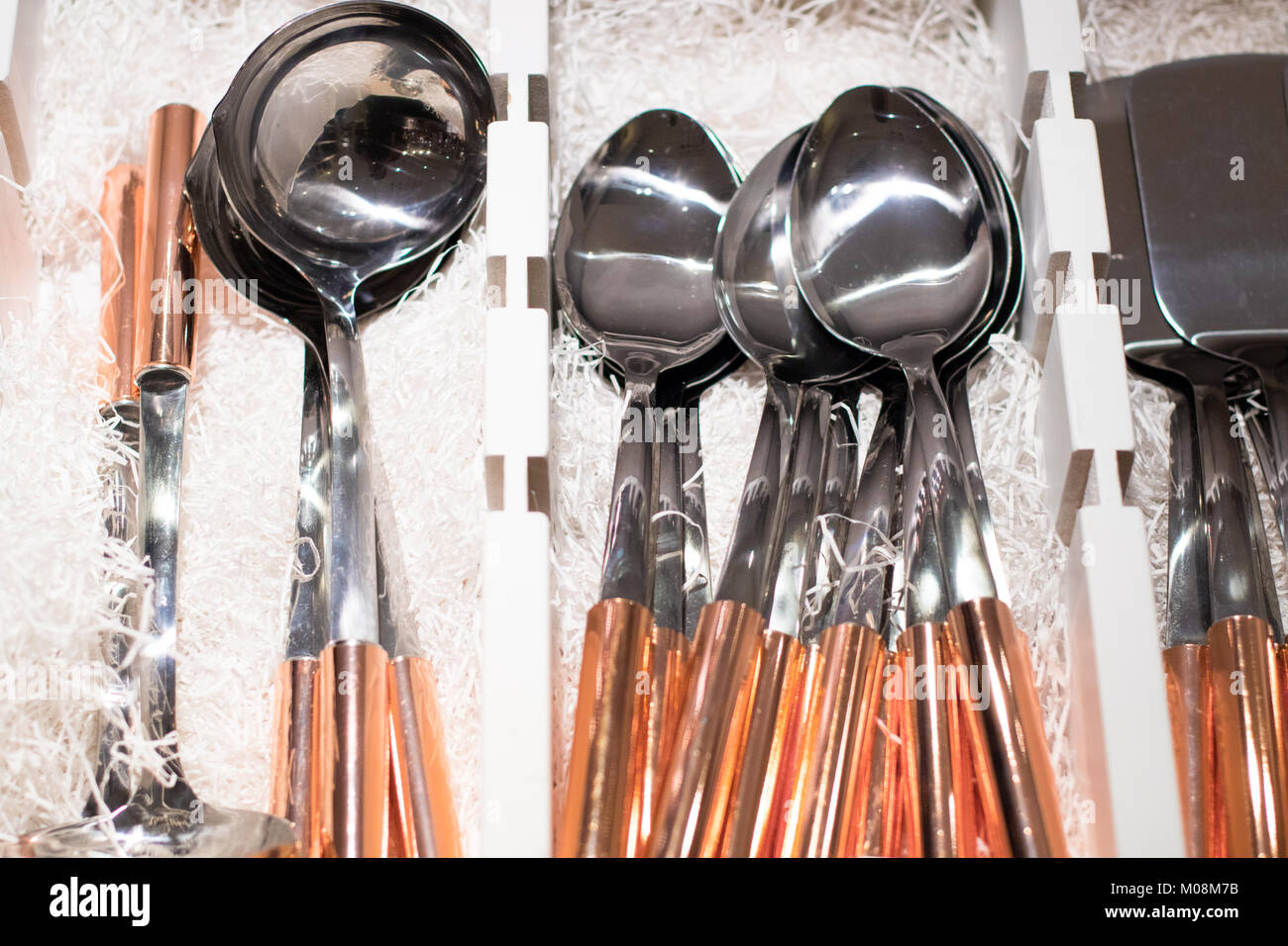 Copper kitchen utensils in sets on displey in the store Stock Photo Alamy