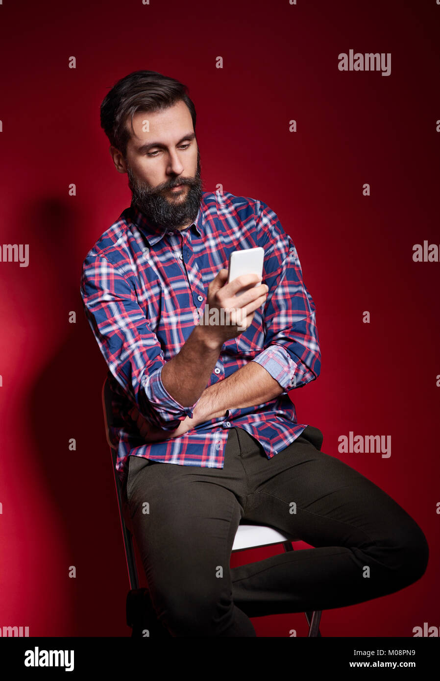 Man sitting chair studio shot hi-res stock photography and images - Alamy